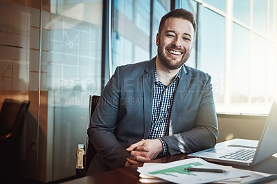 Buy stock photo Cropped portrait of a young businessman working in his office