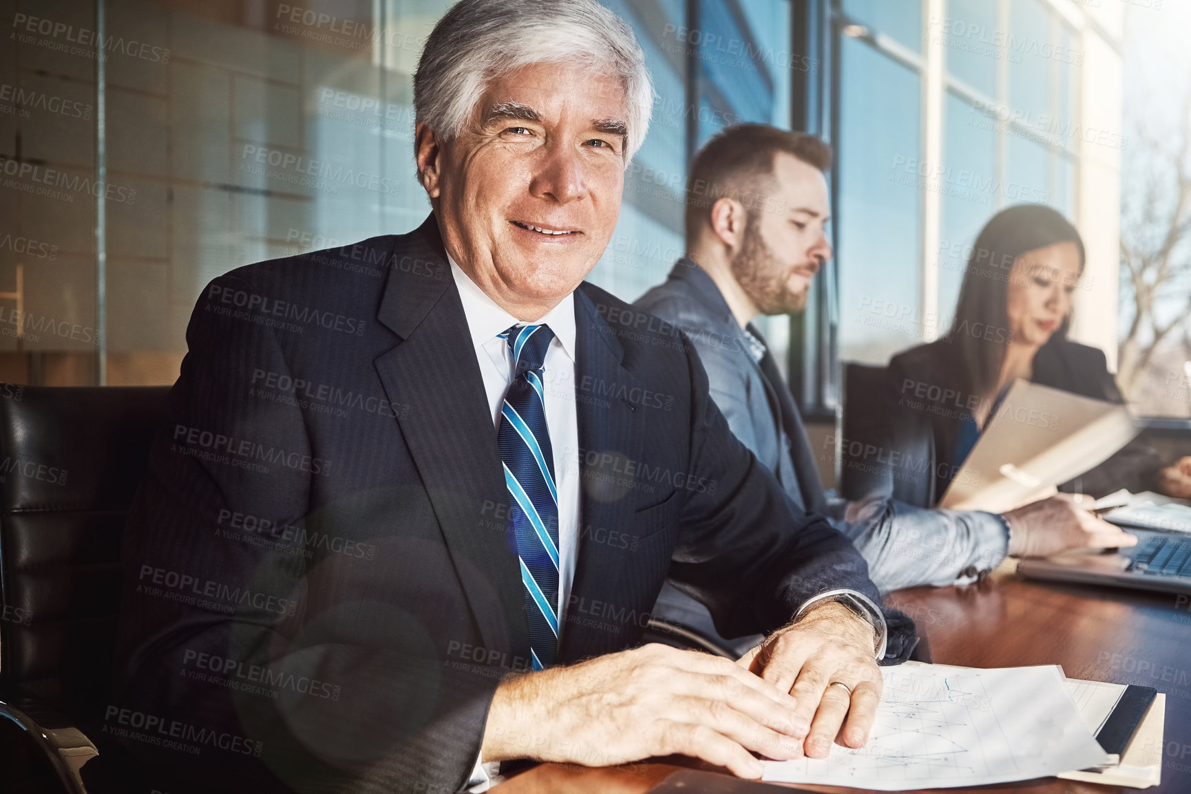 Buy stock photo Cropped portrait of a mature businessman sitting in the boardroom during a meeting