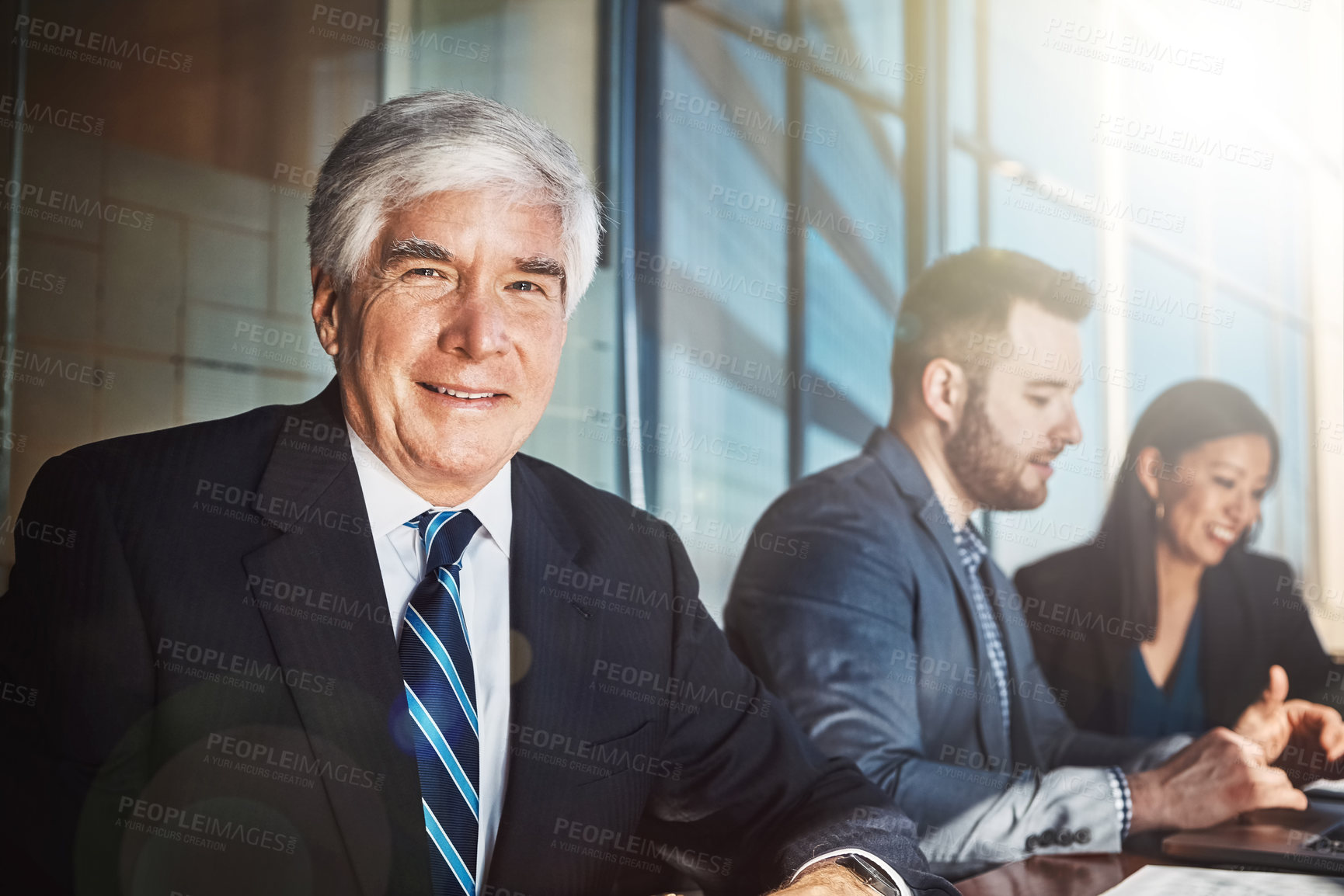 Buy stock photo Cropped portrait of a mature businessman sitting in the boardroom during a meeting