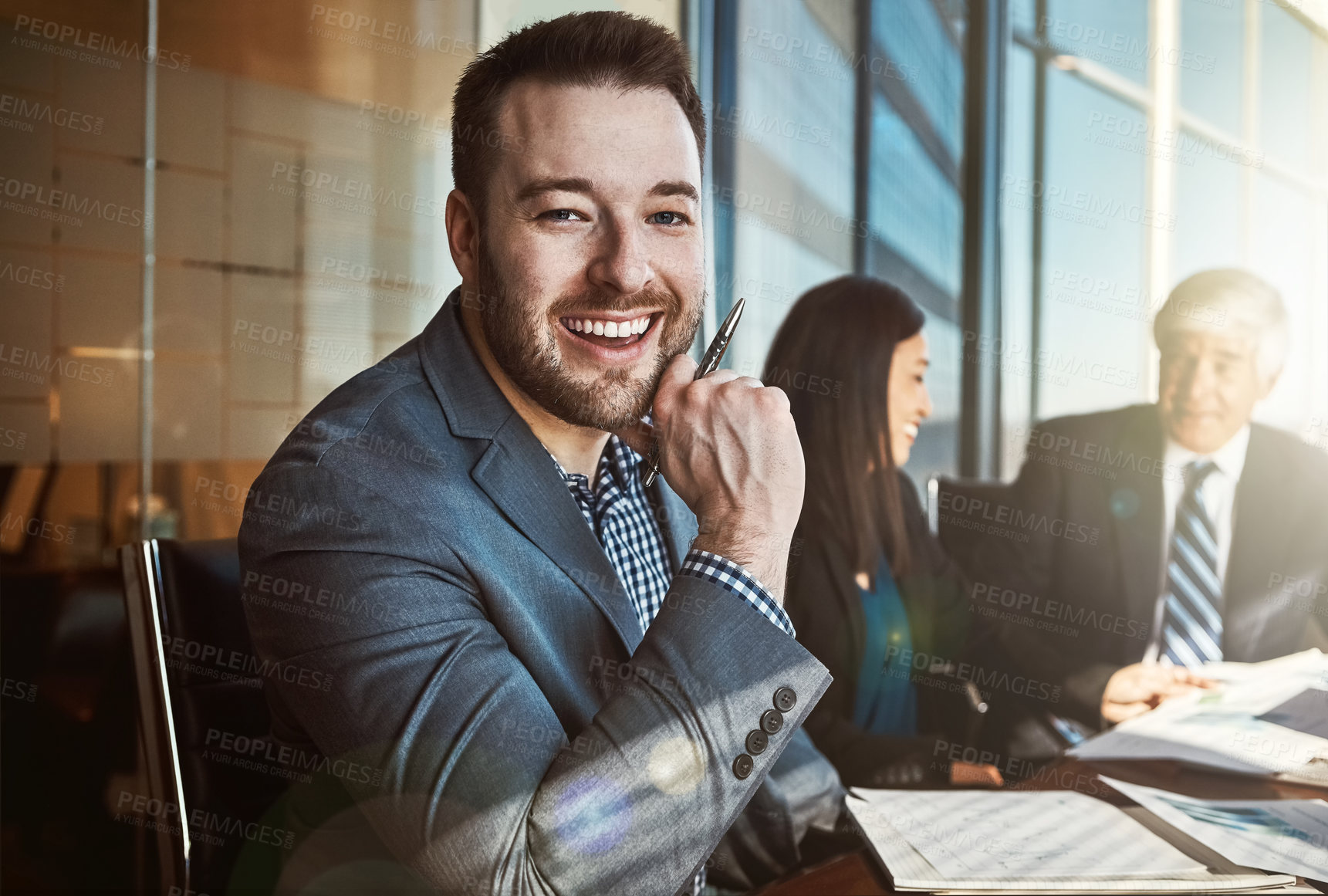 Buy stock photo Cropped portrait of a young businessman sitting in the boardroom during a meeting