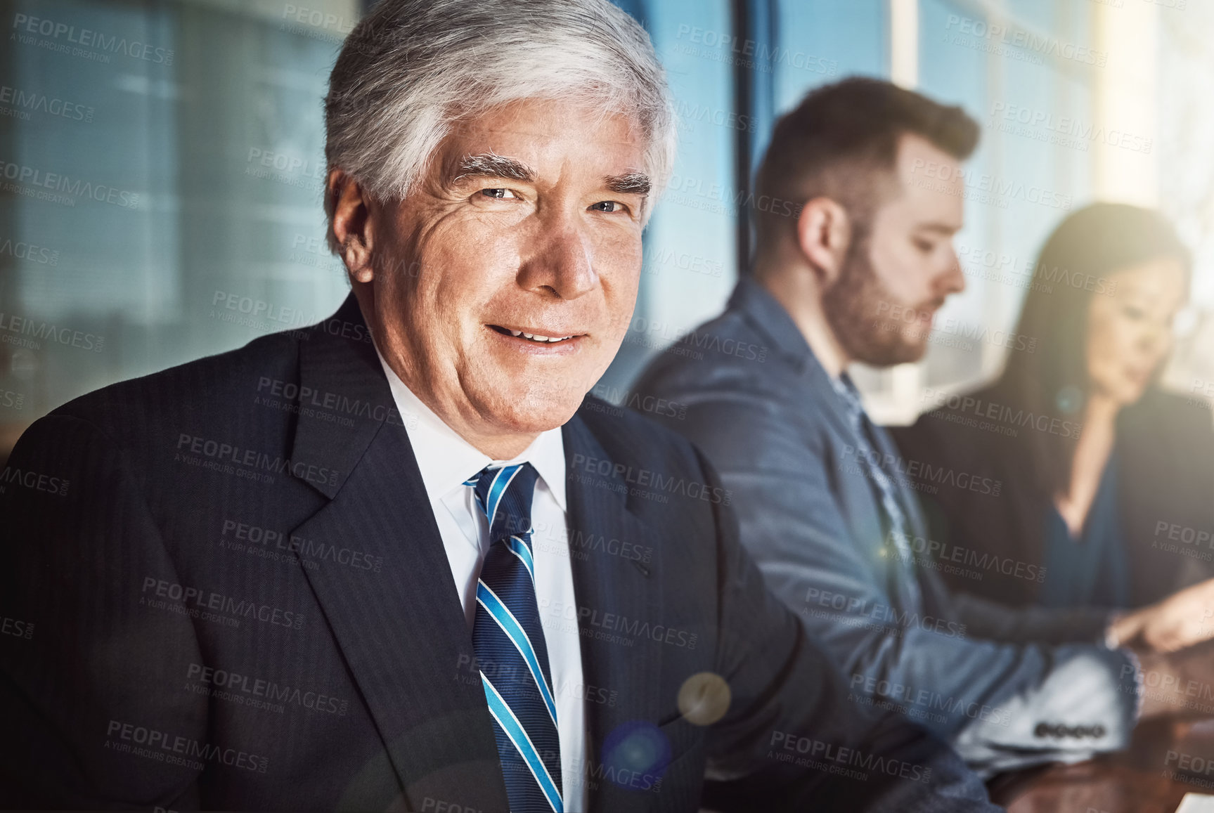 Buy stock photo Cropped portrait of a mature businessman sitting in the boardroom during a meeting