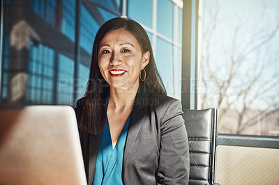 Buy stock photo Cropped portrait of a mature businesswoman working on her laptop in the office