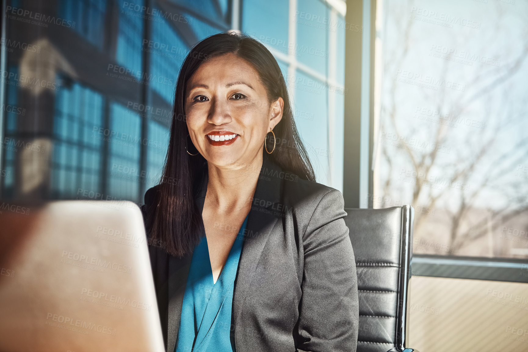 Buy stock photo Cropped portrait of a mature businesswoman working on her laptop in the office