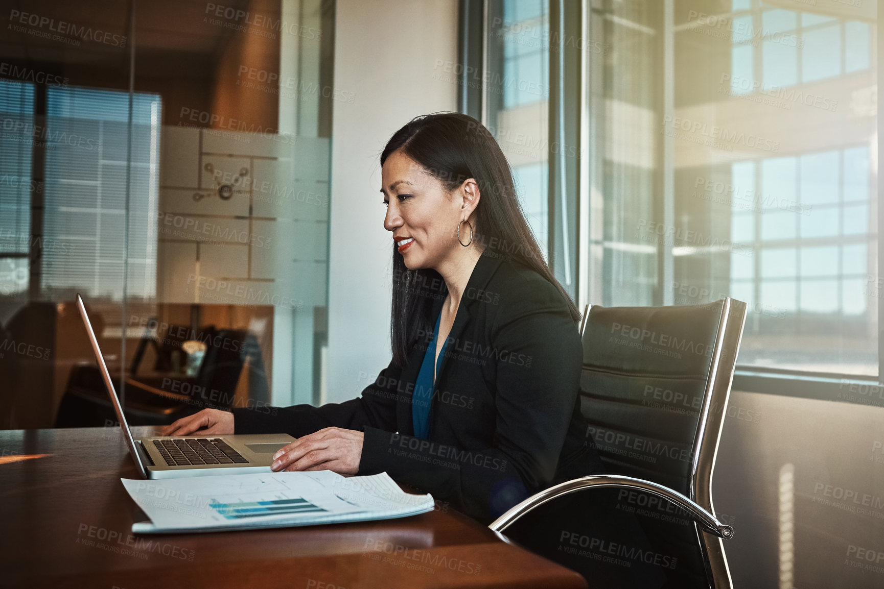 Buy stock photo Cropped shot of a mature businesswoman working on her laptop in the office