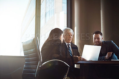 Buy stock photo Cropped shot of three businesspeople working together in the boardroom