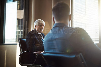 Buy stock photo Cropped shot of two businessmen working together in the boardroom