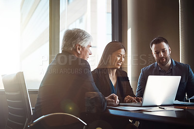 Buy stock photo Cropped shot of three businesspeople working together in the boardroom