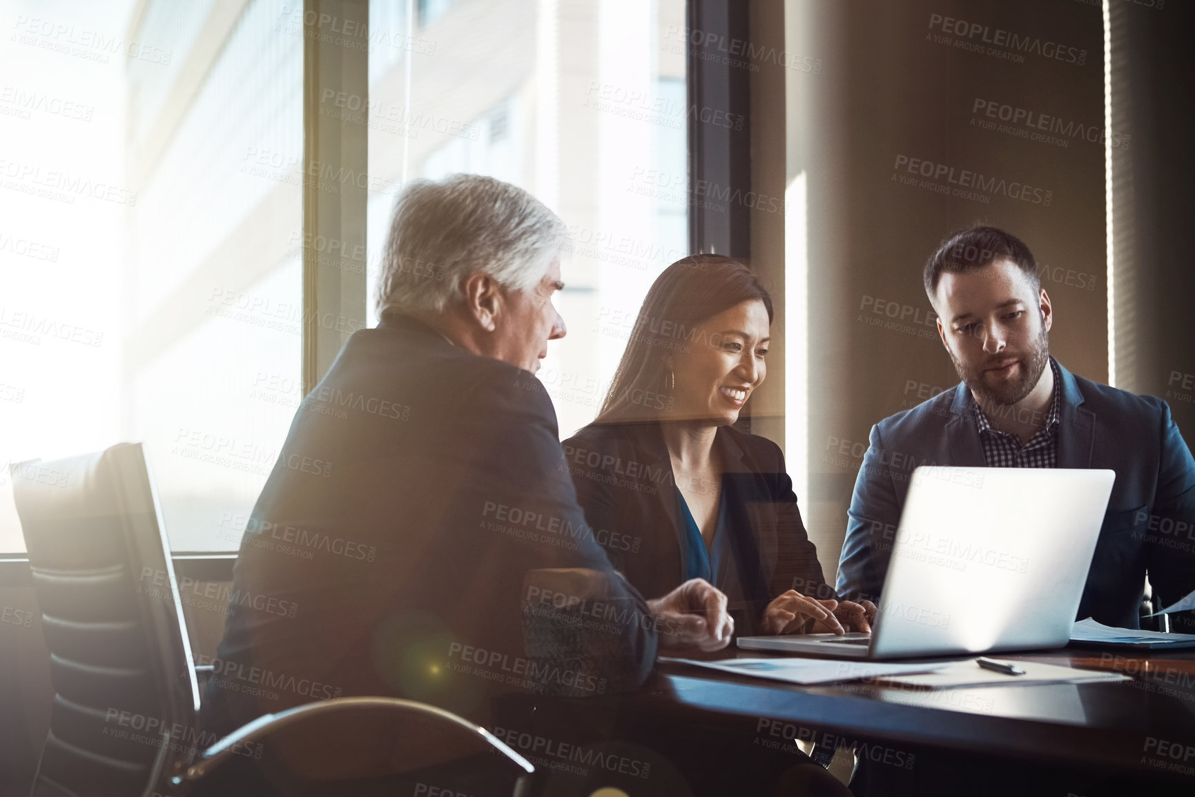 Buy stock photo Cropped shot of three businesspeople working together in the boardroom