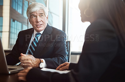 Buy stock photo Cropped shot of two businesspeople working together in the boardroom