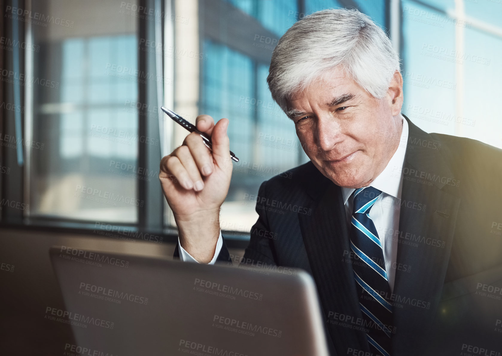 Buy stock photo Cropped shot of a mature businessman working on his laptop in the office