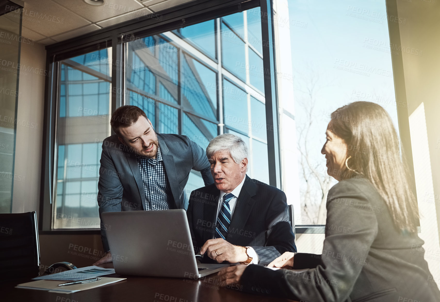 Buy stock photo Cropped shot of three businesspeople working in the boardroom