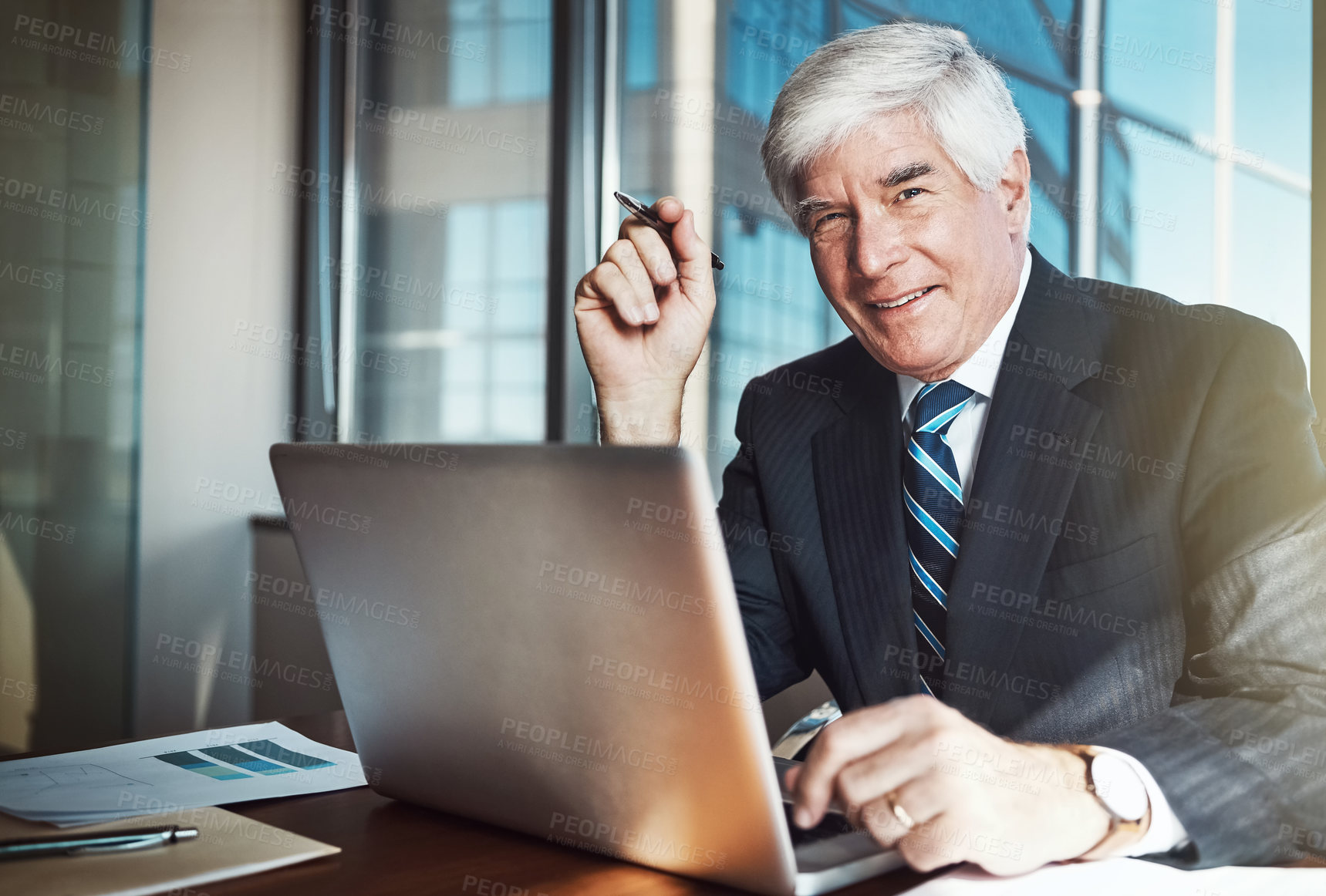 Buy stock photo Cropped portrait of a mature businessman working on his laptop in the office