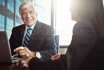 Buy stock photo Cropped shot of two businesspeople working together in the boardroom