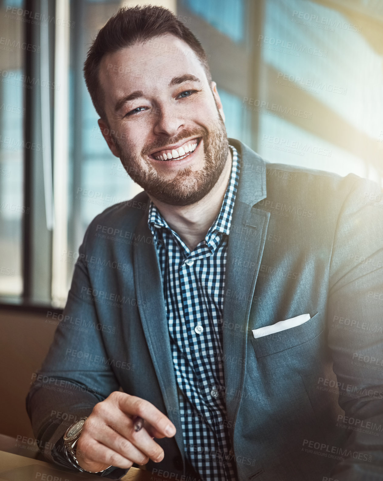 Buy stock photo Cropped portrait of a young businessman working in his office