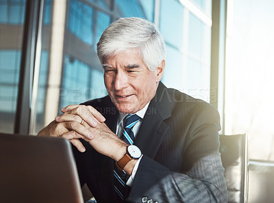 Buy stock photo Cropped shot of a mature businessman working on his laptop in the office