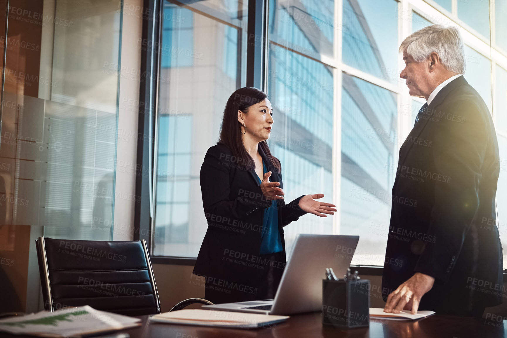 Buy stock photo Business man, woman and discussion in boardroom with documents, computer or feedback at financial agency. People, risk analyst and senior manager with talk, question or collaboration in modern office