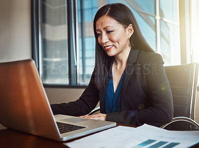 Buy stock photo Cropped shot of a mature businesswoman working on her laptop in the office