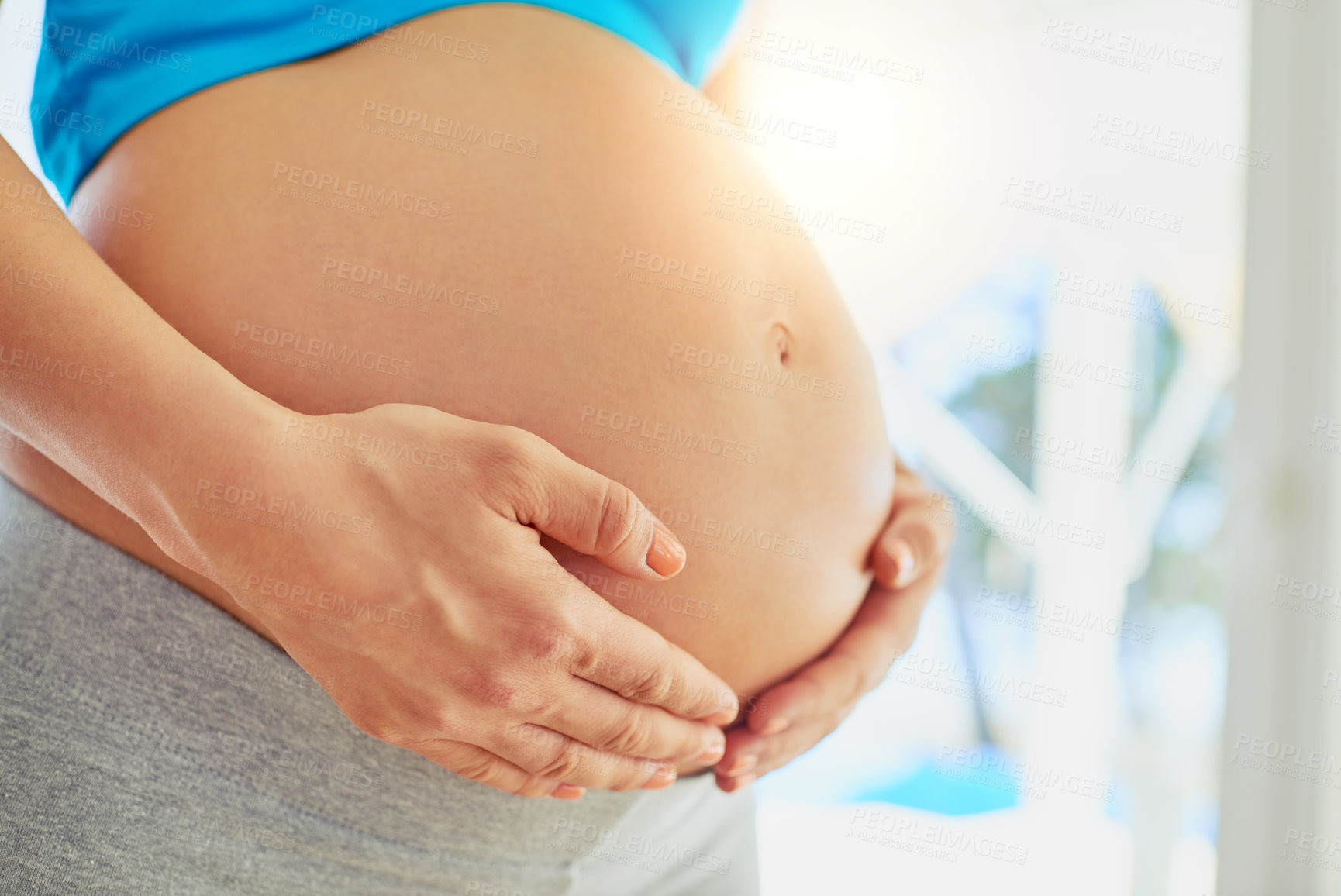 Buy stock photo Pregnant, love and hands of woman in home by window for comforting, bonding and support in morning. Maternity, pregnancy and person holding stomach for motherhood, fertility health and wellness