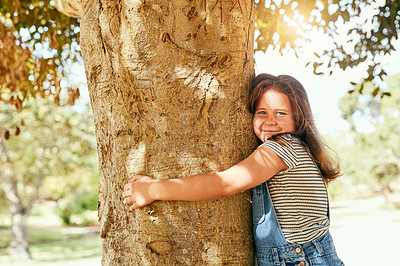 Buy stock photo Park, girl and smile with holding tree on portrait for playing, fun or enjoy and child development. Outdoor, kid and happy person for summer vacation or school holiday with activity and routine