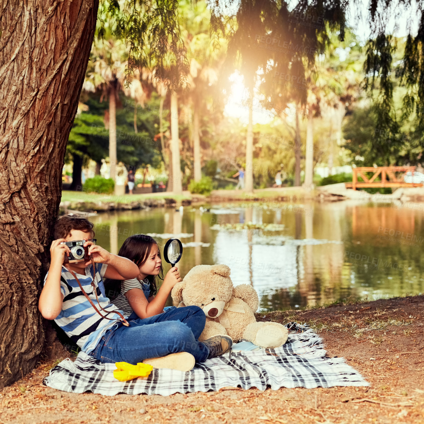 Buy stock photo Picnic, kids or camera in nature with picture photography or magnifying glass for fun games, travel or playing. Friends, photo and children in forest for holiday adventure or wilderness environment