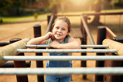 Buy stock photo Portrait of a little girl playing on the jungle gym at the park