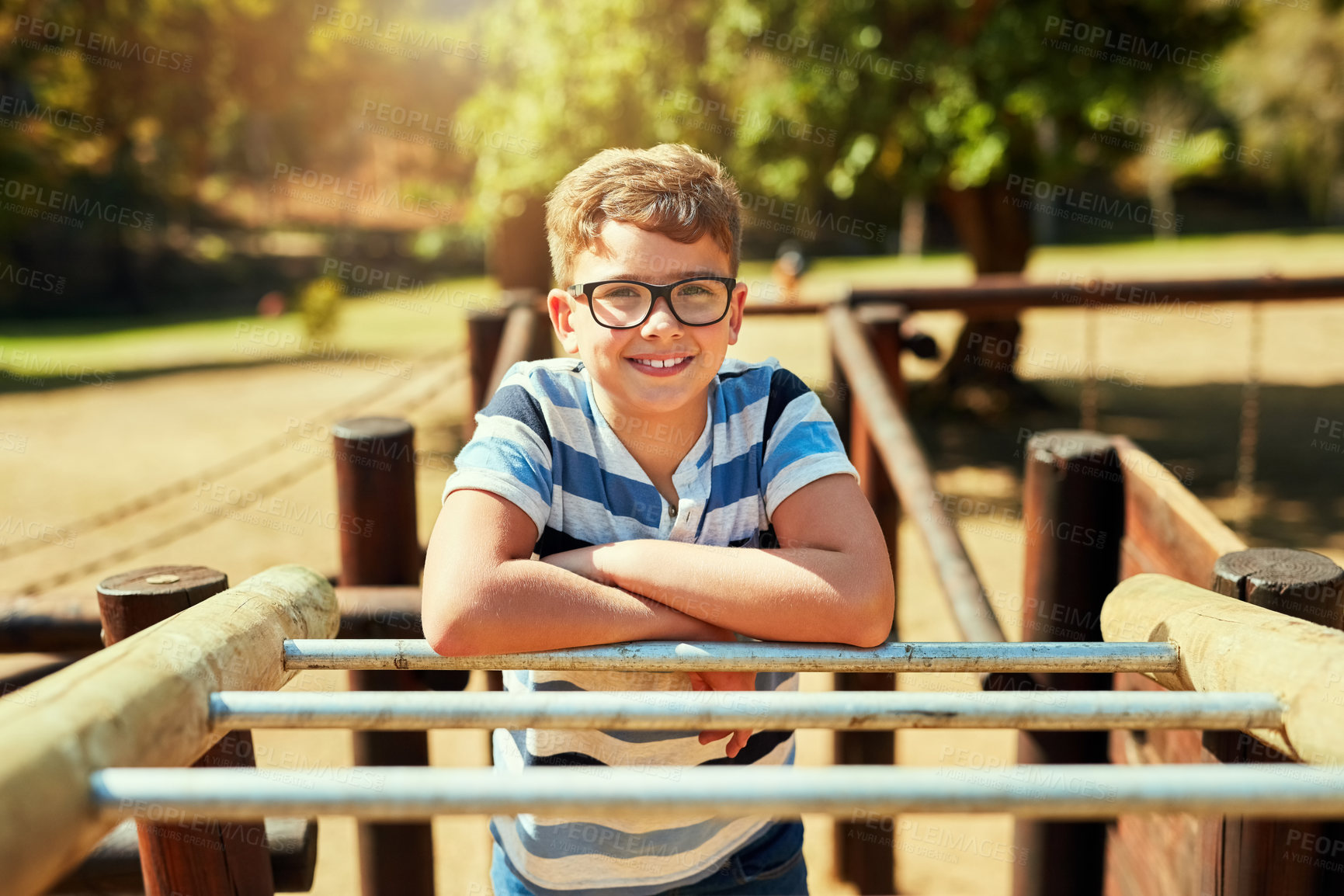 Buy stock photo Portrait of a little boy playing on the jungle gym at the park