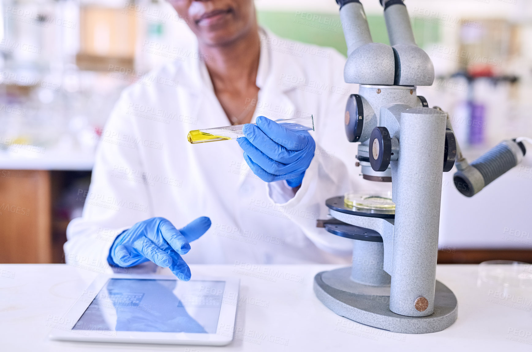Buy stock photo Shot of a female scientist working on a digital tablet in a lab