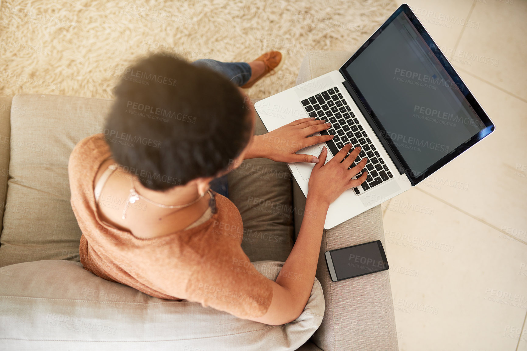 Buy stock photo Shot of an unrecognizable woman using a laptop at home