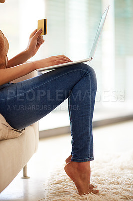 Buy stock photo Shot of an unrecognizable woman using a laptop and credit card at home