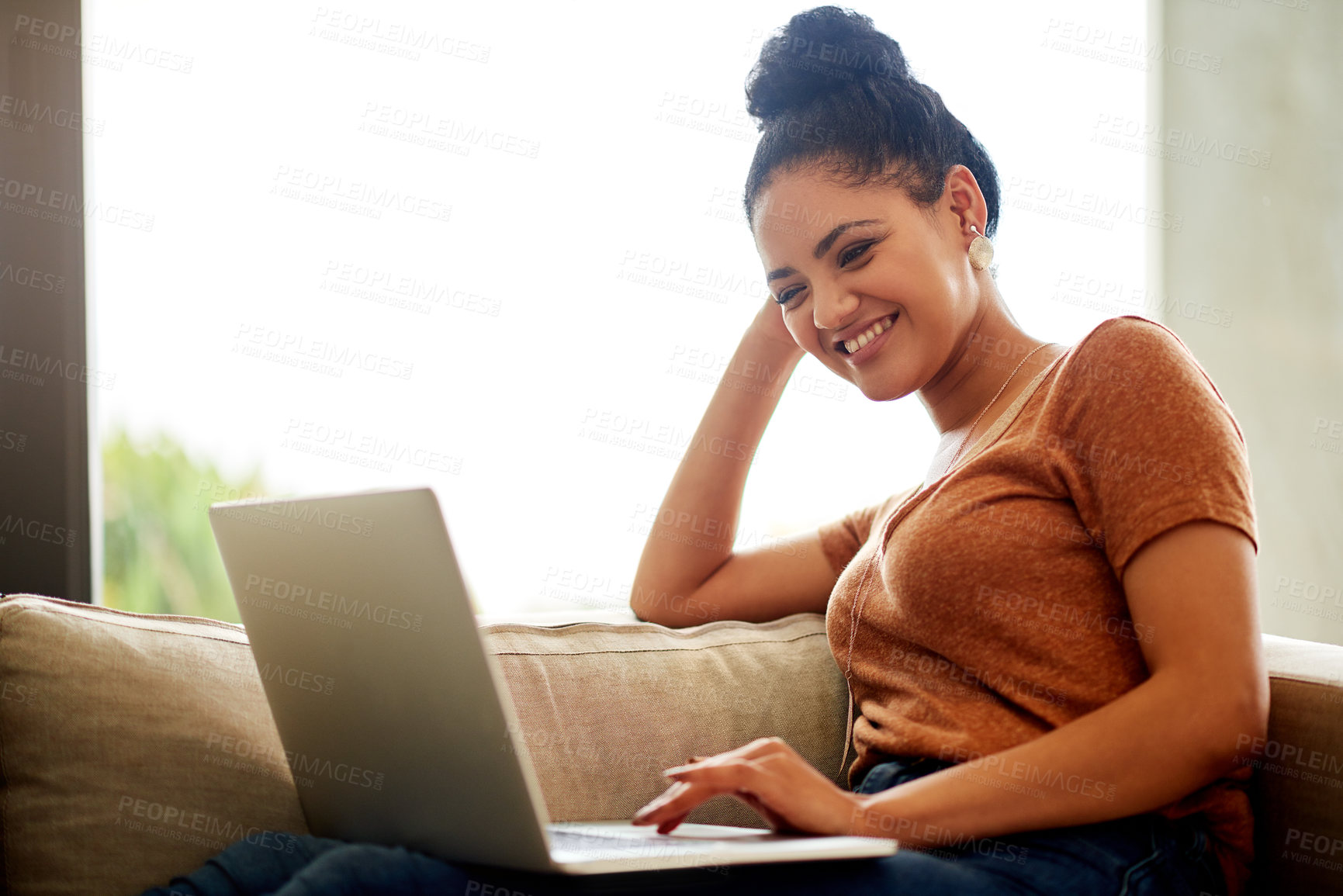 Buy stock photo Shot of a beautiful young woman using a laptop at home