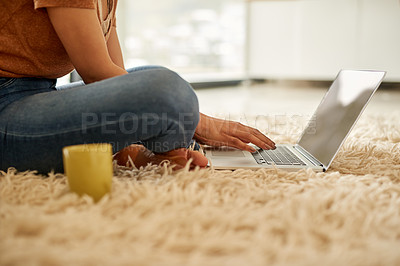 Buy stock photo Shot of an unrecognizable woman using a laptop at home