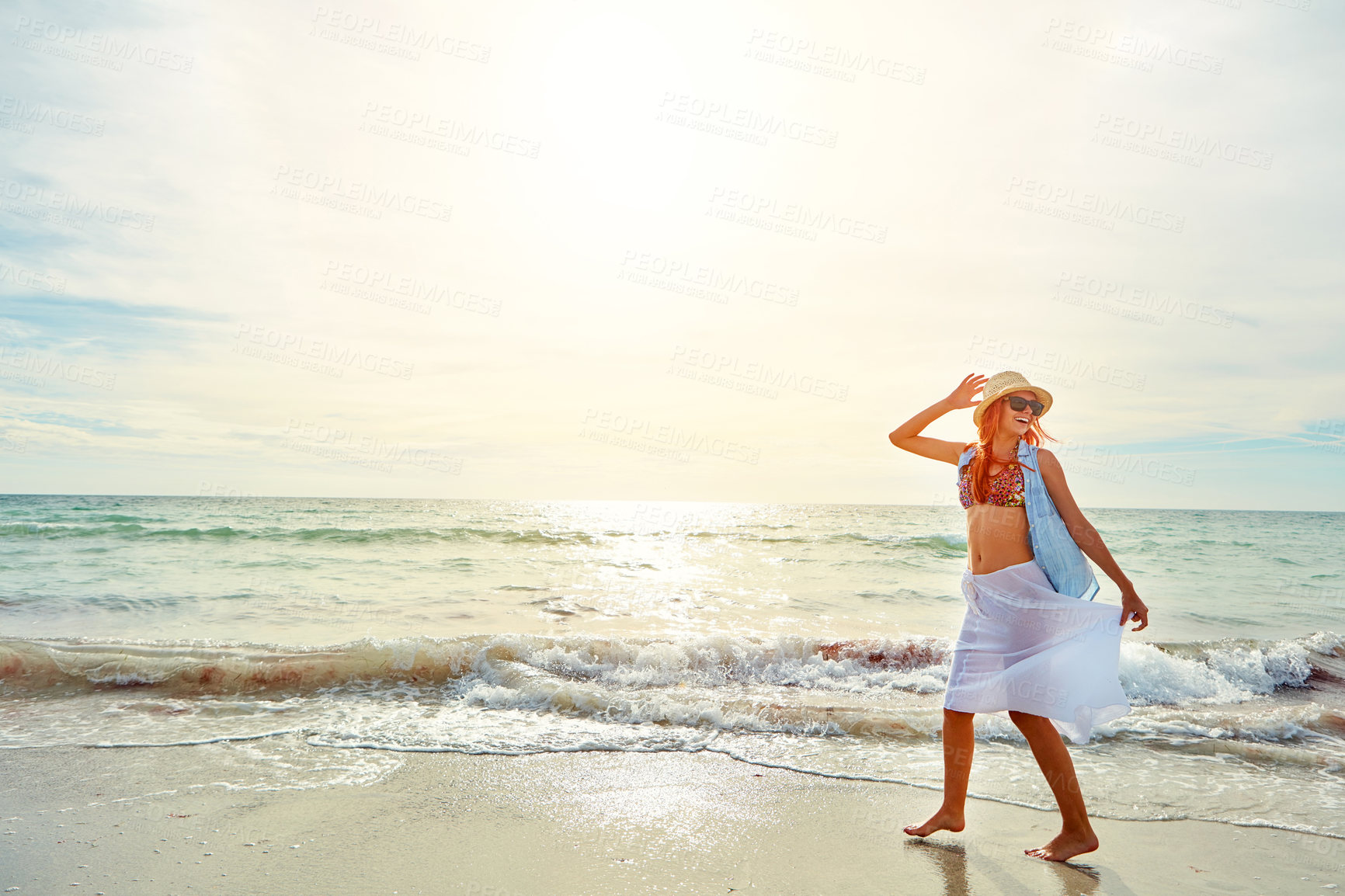 Buy stock photo Shot an attractive young woman enjoying a day at the beach