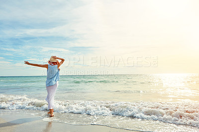 Buy stock photo Shot an attractive young woman enjoying a day at the beach