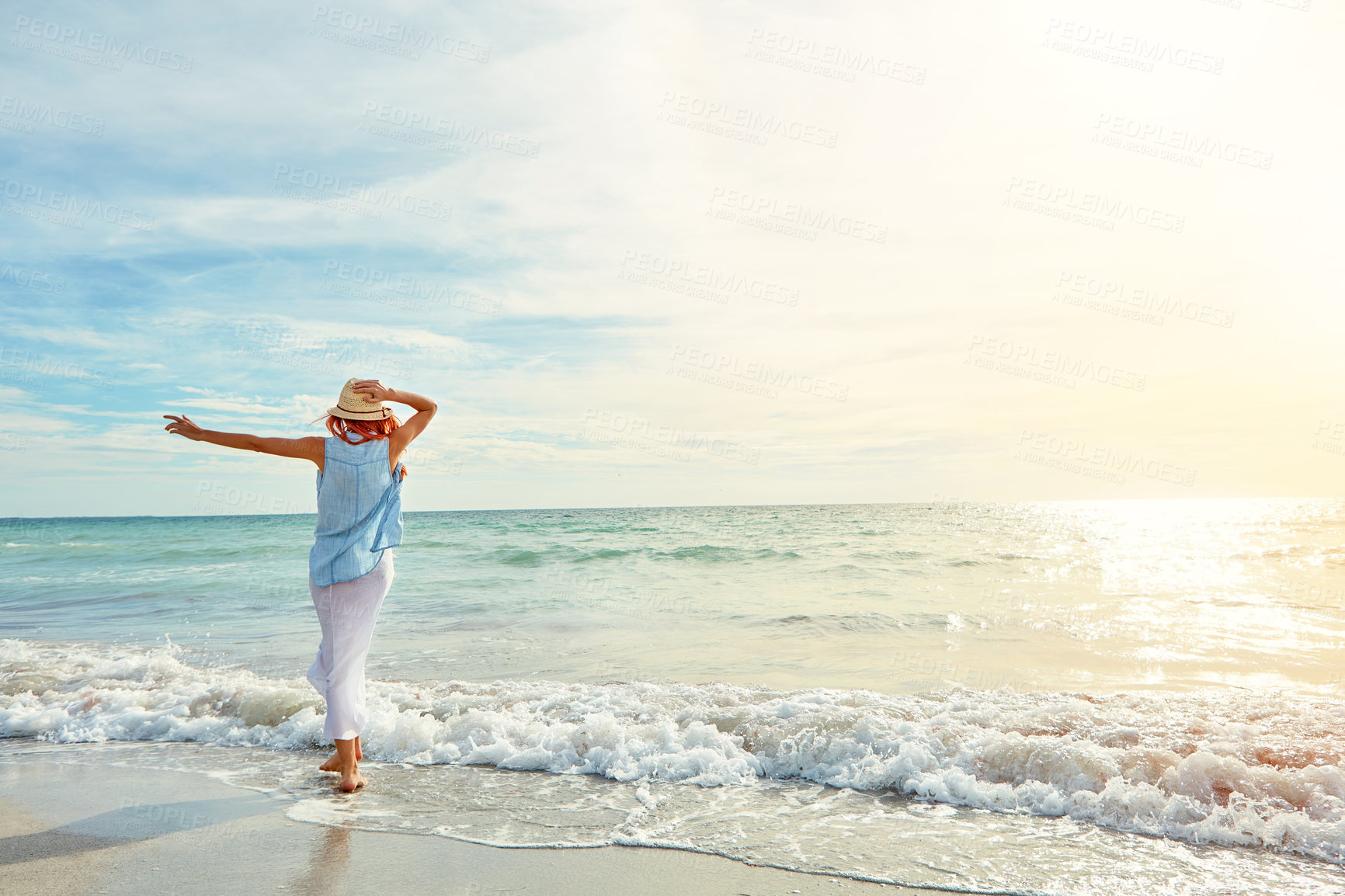 Buy stock photo Shot an attractive young woman enjoying a day at the beach