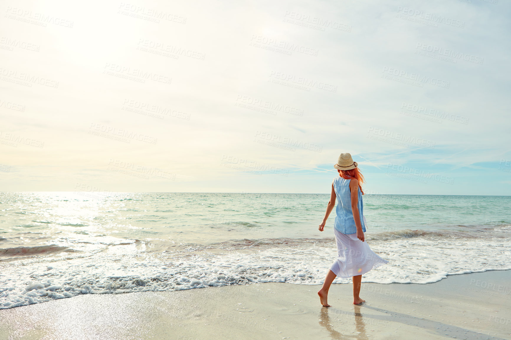 Buy stock photo Shot an attractive young woman enjoying a day at the beach