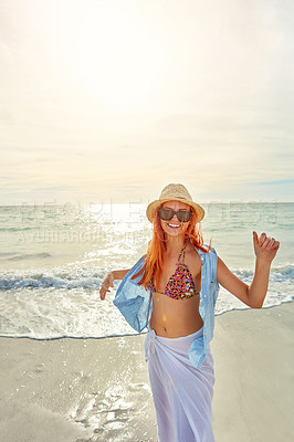 Buy stock photo Portrait an attractive young woman enjoying a day at the beach