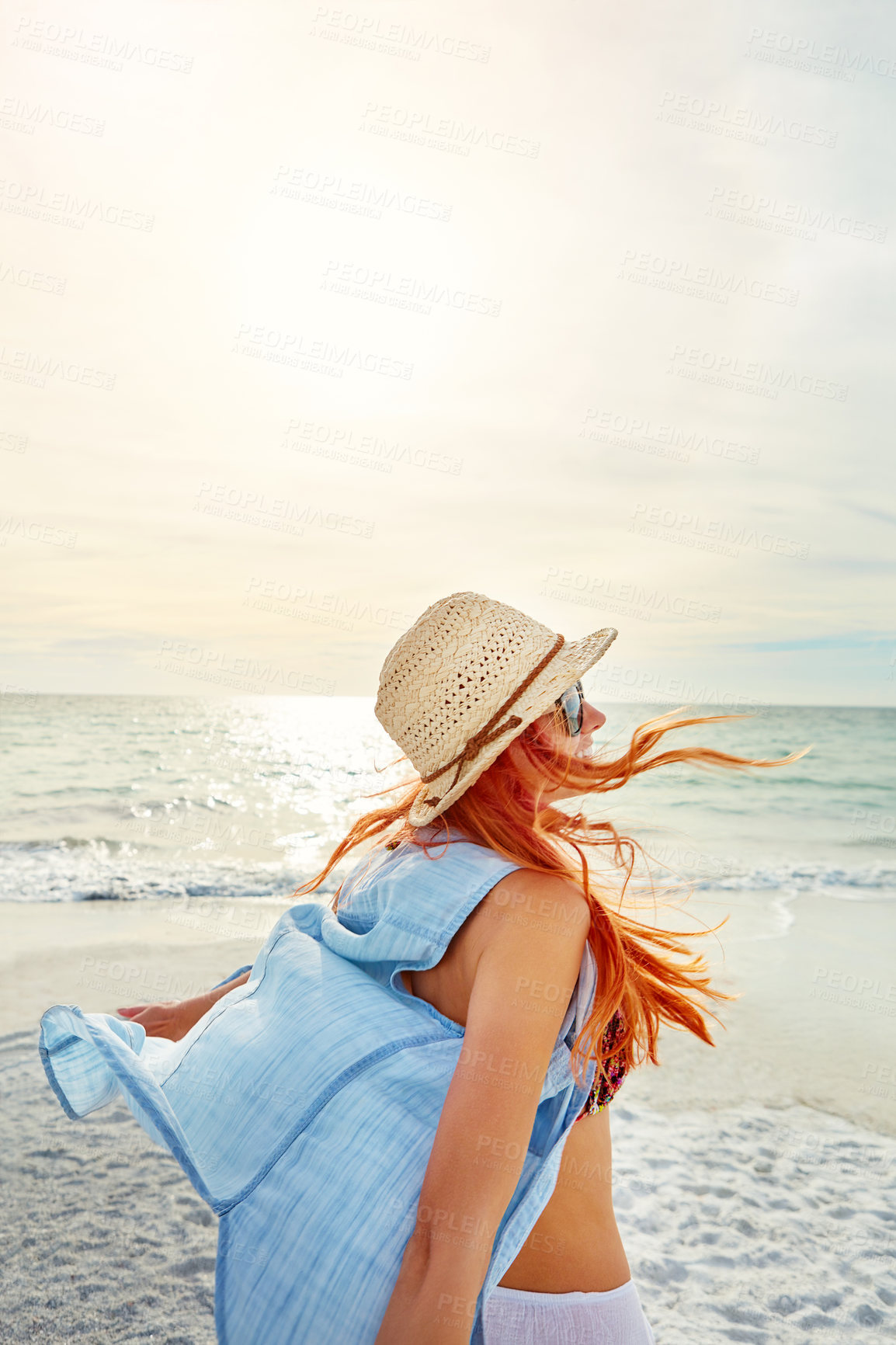 Buy stock photo Shot an attractive young woman enjoying a day at the beach