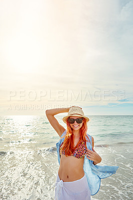 Buy stock photo Portrait an attractive young woman enjoying a day at the beach