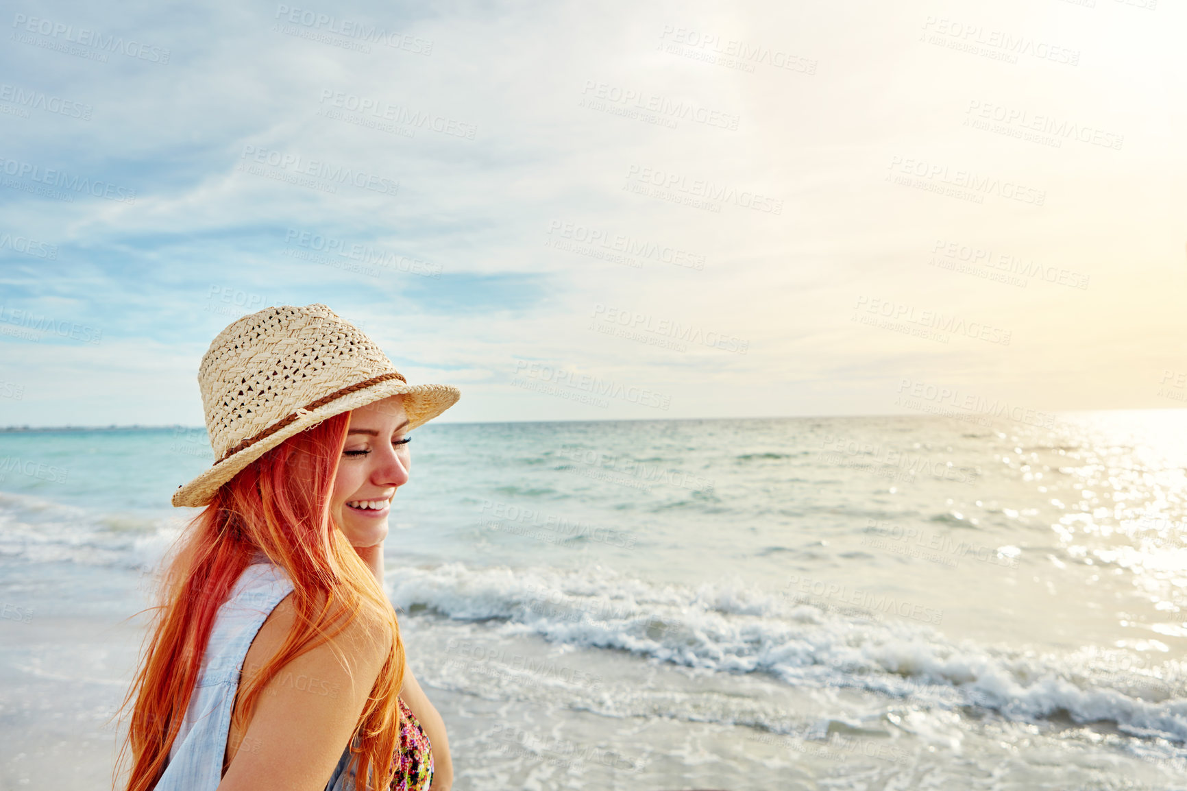 Buy stock photo Shot an attractive young woman enjoying a day at the beach