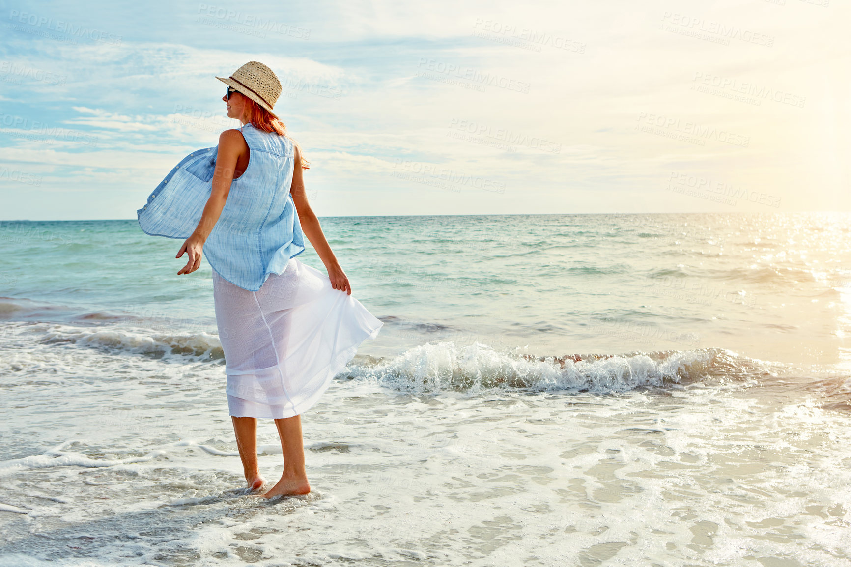 Buy stock photo Shot an attractive young woman enjoying a day at the beach