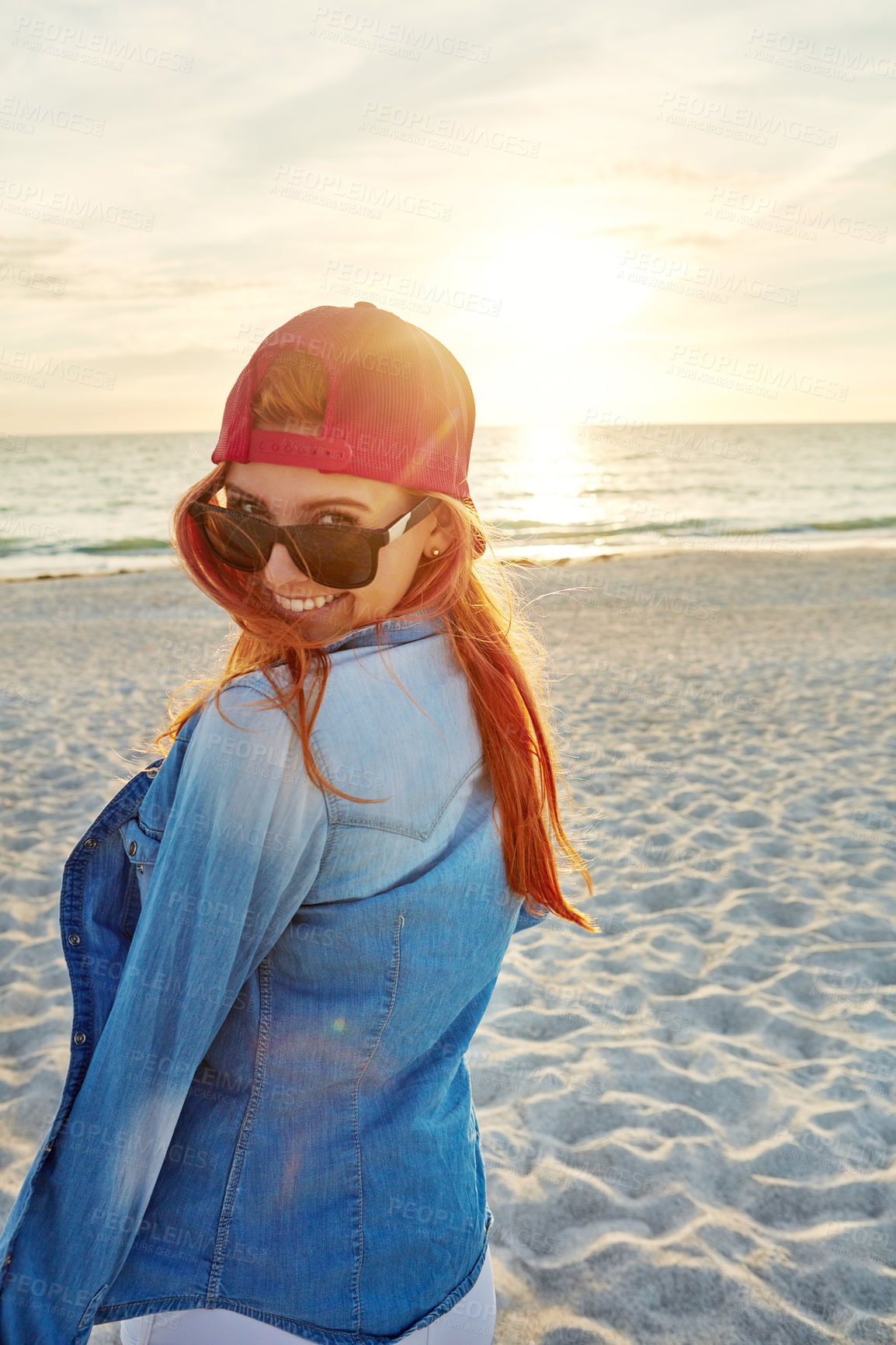 Buy stock photo Portrait an attractive young woman enjoying a day at the beach