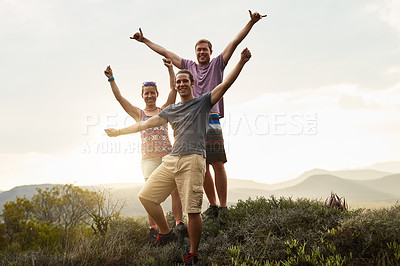 Buy stock photo Portrait of three happy friends posing together during a hike in the mountains