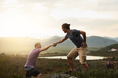 Buy stock photo Hiker helping friend while hiking, fitness and men outdoor trekking in nature or countryside for exercise and travel. Young people hike together, support and adventure with friends, bond and workout