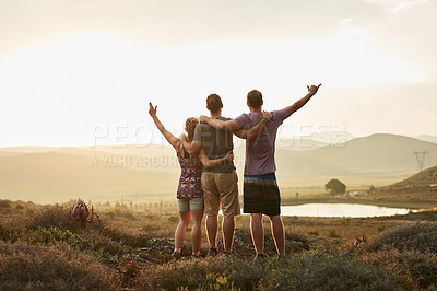 Buy stock photo Rearview shot of three happy hikers taking in the view on a mountain trail