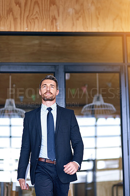 Buy stock photo Shot of a confident businessman walking into his office