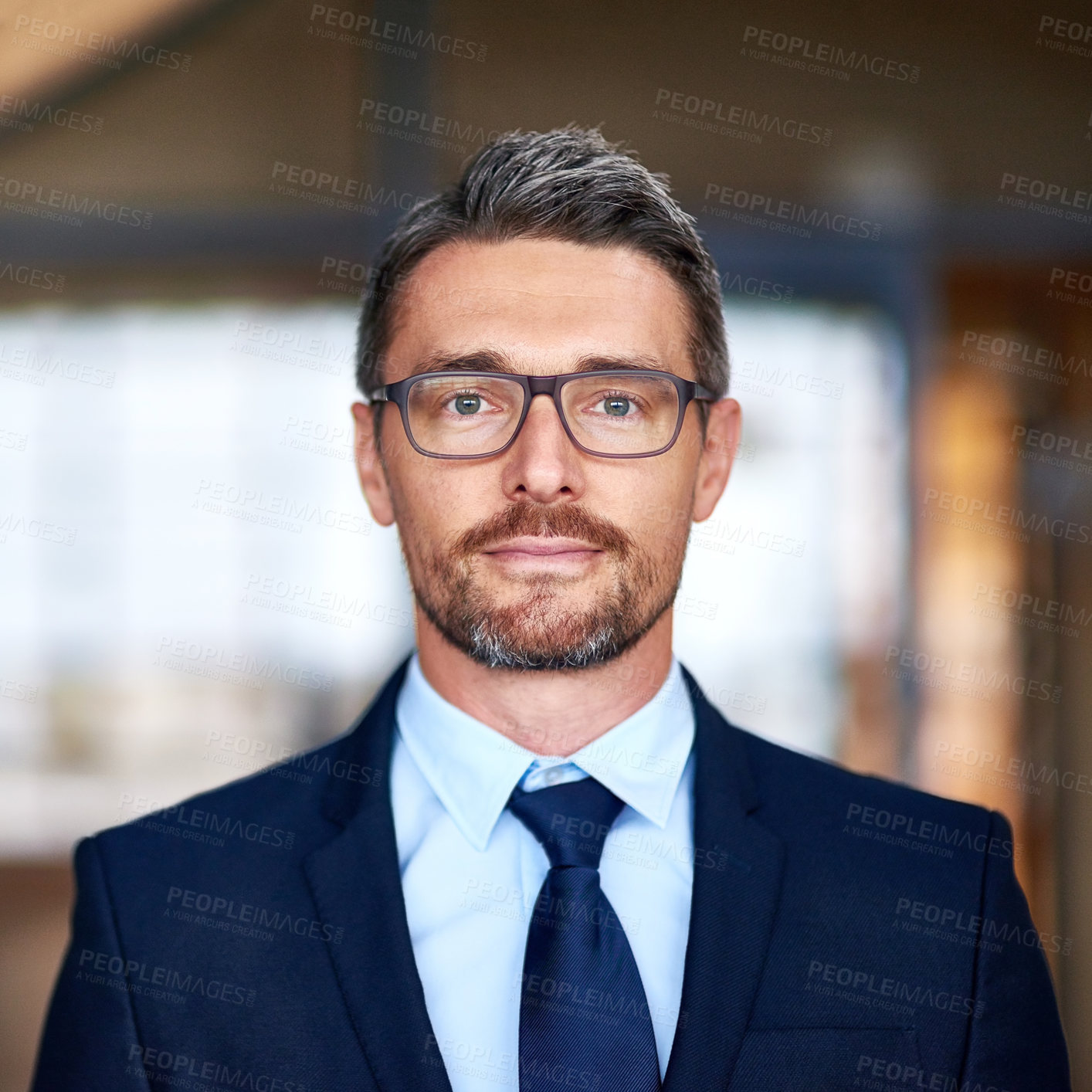 Buy stock photo Portrait of a confident businessman smiling while standing in his office