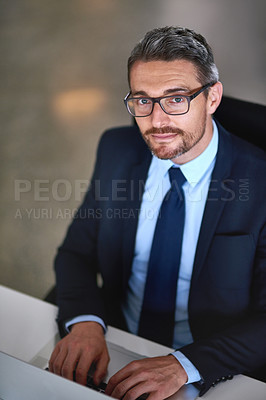 Buy stock photo Portrait, laptop and businessman typing at desk with research, legal advice and networking at law firm. Lawyer, attorney or mature man with computer, writing email and consulting for online feedback.