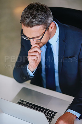 Buy stock photo Office, laptop and businessman thinking at desk with research, review or online consulting at agency. Professional idea, business plan or mature man checking email, feedback or brainstorming article 