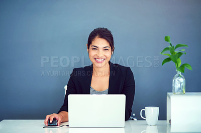 Buy stock photo Portrait of a happy young businesswoman working behind her laptop in the office