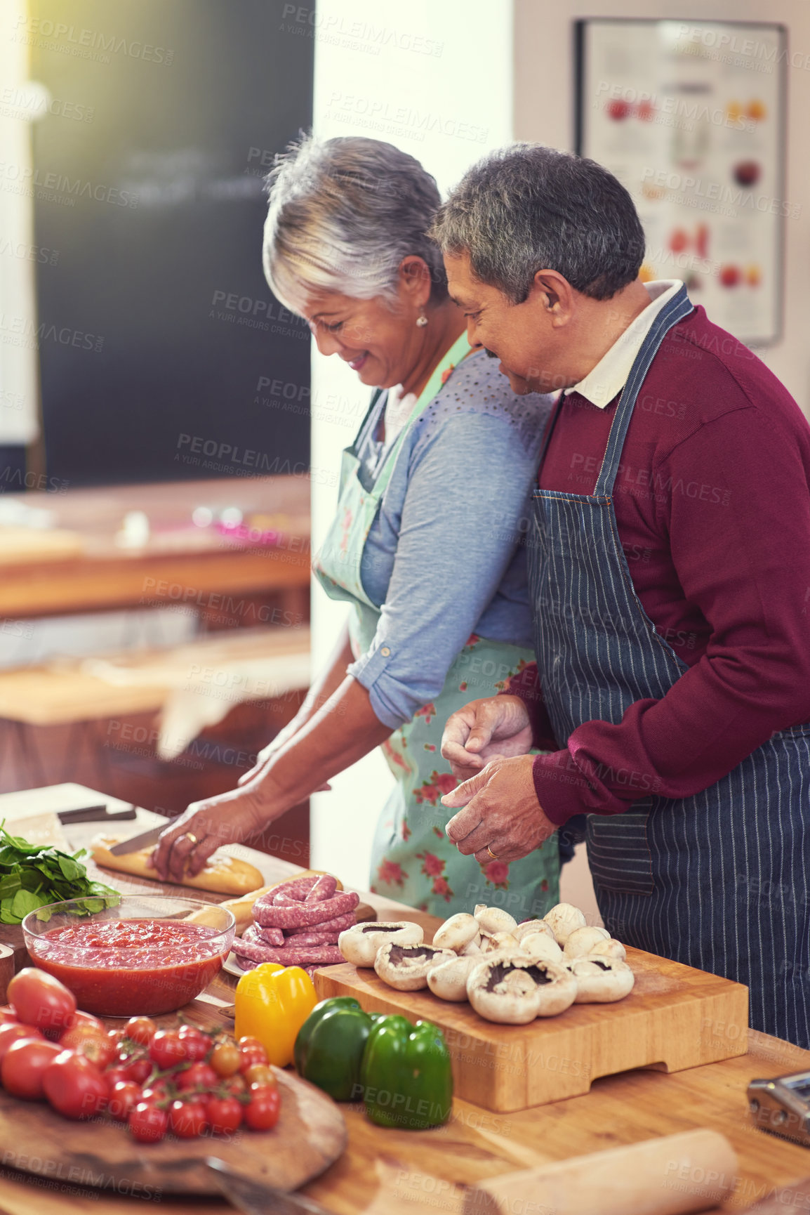 Buy stock photo Cooking, vegetables and senior couple in kitchen at home with cutting ingredients for meal. Love, food and elderly man and woman preparing dinner, lunch or supper together at house in Mexico.